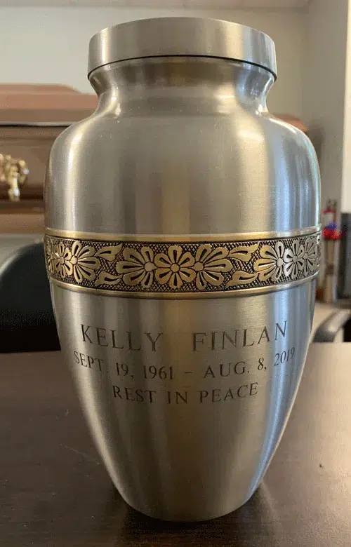 Classic Flower Metal Urn MU225, brushed pewter finish with a gold flower band, engraved with a name, dates and epitaph