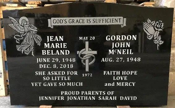 Black granite companion headstone with an etched angel, praying hands with a rose, and a cross with wedding rings