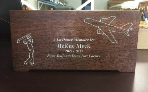 Engraved Walnut Urn with Golfer and Airplane Dark walnut wood urn with silver filled engraving of a golfer, an airplane and a French memorial inscription