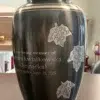 Falling Leaves Metal Urn MU184 Engraved Falling Leaves Metal Urn MU184, charcoal grey with three silver maple leaves and an engraved name and dates
