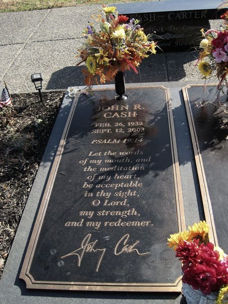 Flat bronze marker with raised lettering and a vase of flowers at Hendersonville Memory Gardens, Tennessee