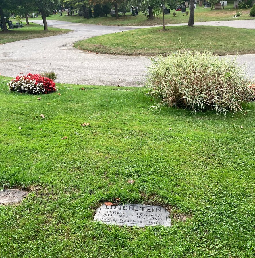 Small grey flat marker with a short personal inscription, set level with the lawn at Mount Pleasant Cemetery, Toronto