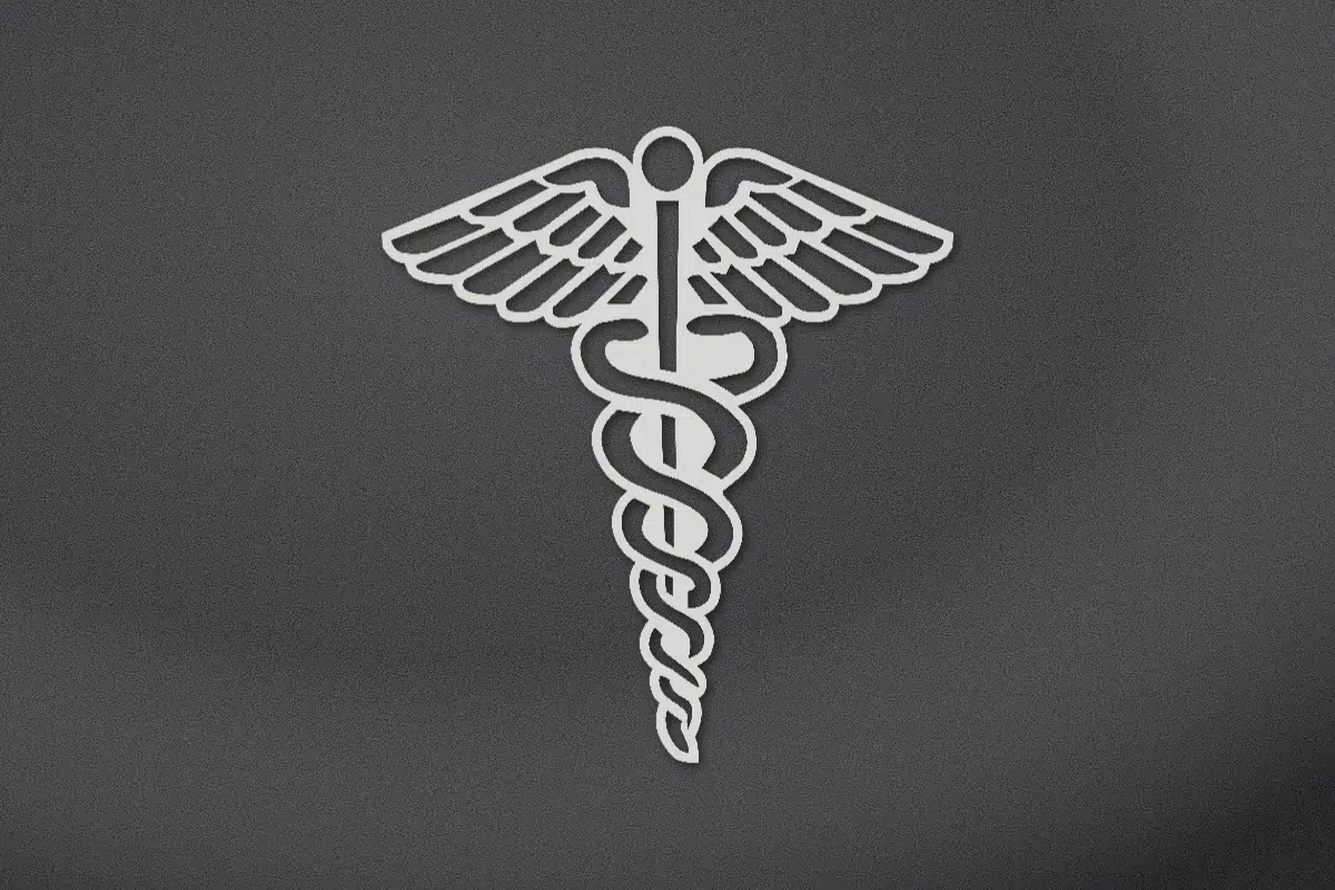 Caduceus with two snakes and wings engraved on black granite