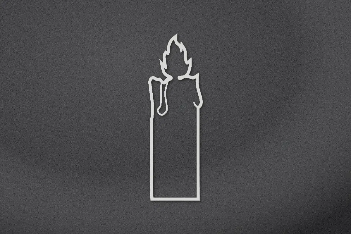 Burning candle engraved on black granite