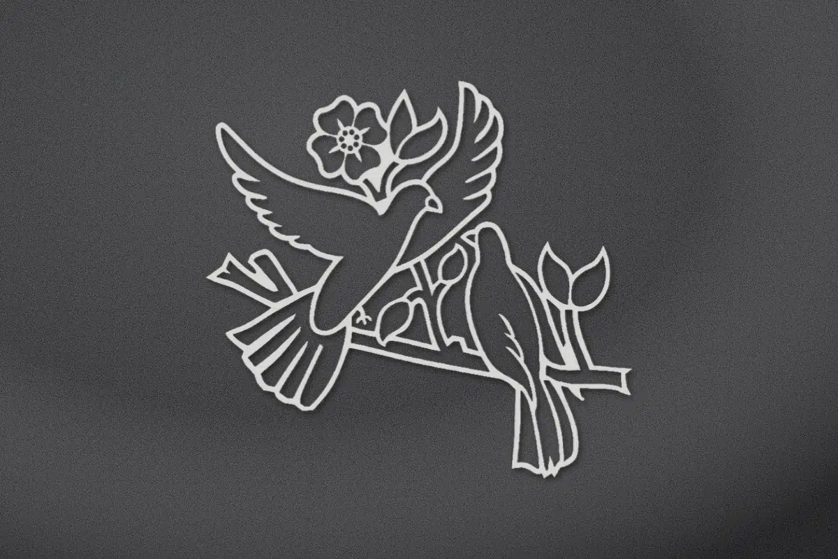 Pair of doves on a flowering branch engraved on black granite