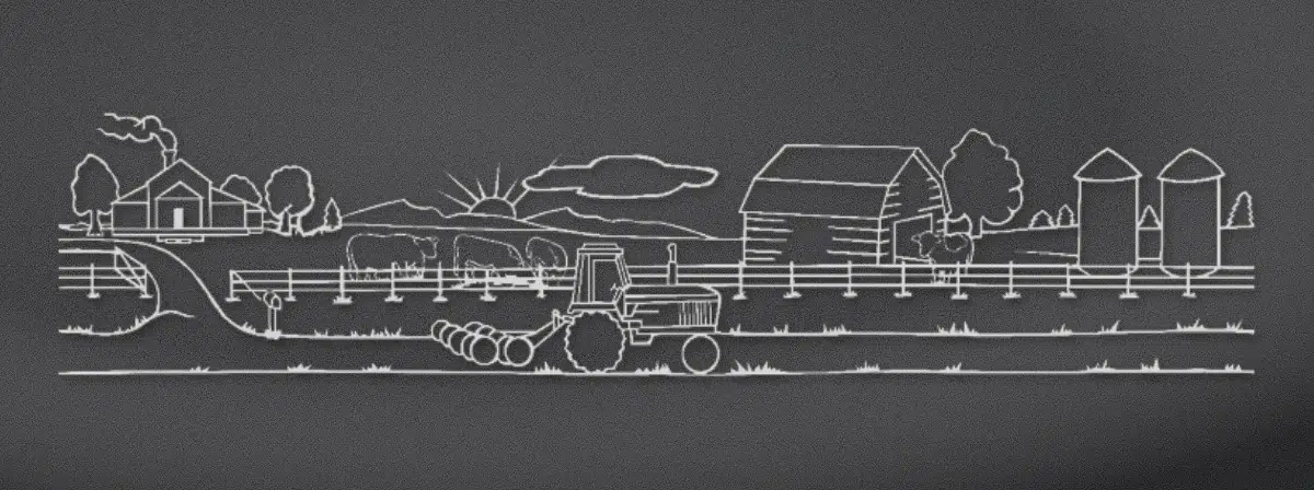 Farm scene with a barn, tractor and cattle engraved on black granite