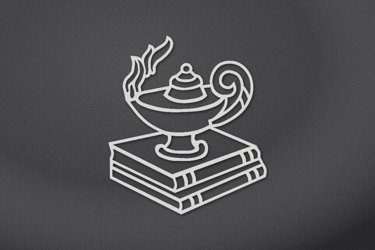 Lamp of knowledge on books engraved on black granite