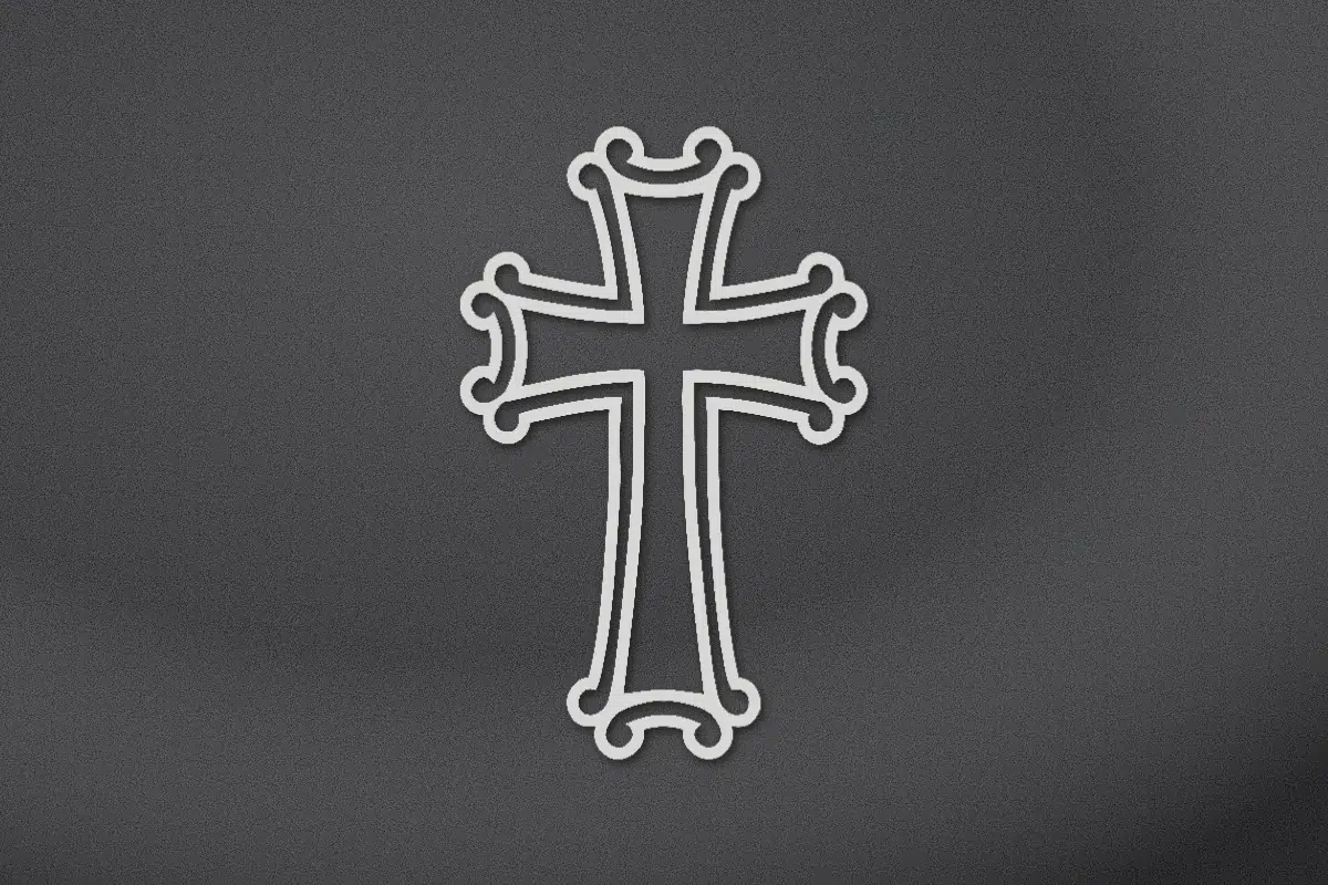 Ornate cross with flared arms engraved on black granite