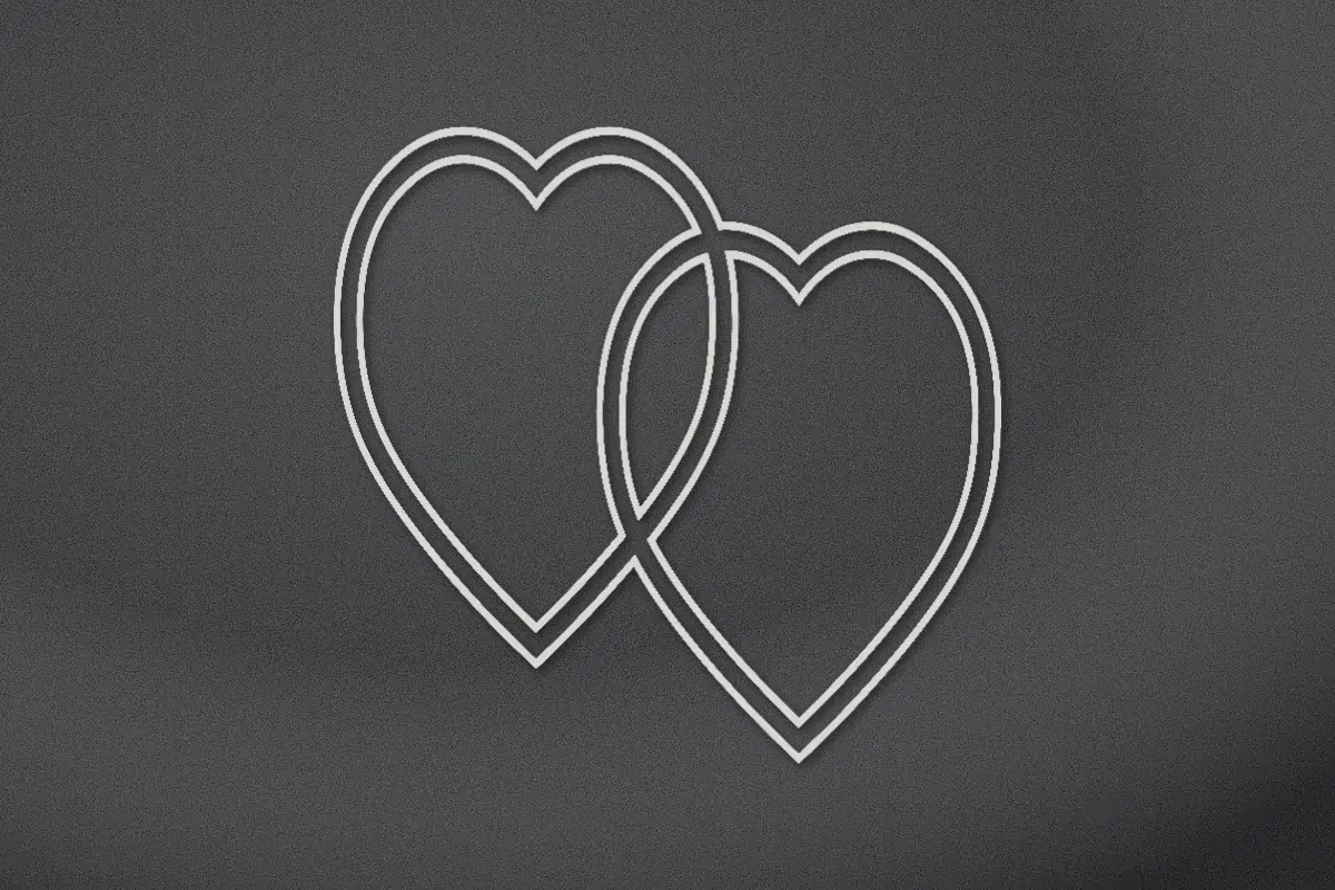 Two joined hearts engraved on black granite