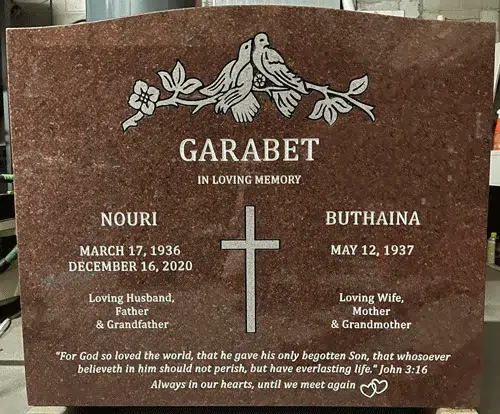 Indian Red granite companion headstone with two doves on a branch, a Latin cross, two names with dates and a Bible verse