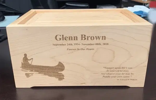 Laser Engraved Maple Wood Urn with Canoe Laser engraved light maple wood urn with a name, dates, a short epitaph, a canoe paddler scene and a four line verse