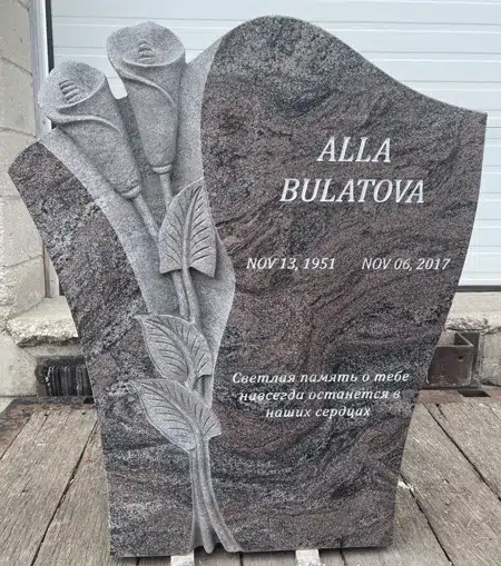 Paradiso granite headstone with sculpted calla lilies carved in relief