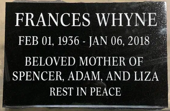 Polished black granite flat grave marker with lettering only, a name, dates, a family dedication and a closing line