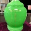 Royal Green Jade Urn MAU204, glossy bright green jar shaped urn with gold engraved name and dates in English and Chinese