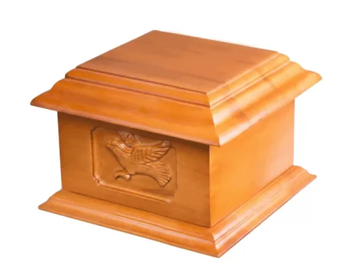 Soaring Dove Wood Urn WU103, light honey wood box urn with a carved dove in flight on the front panel