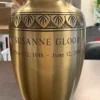 Sunlight Gleam Metal Urn MU105 Sunlight Gleam Metal Urn MU105, brushed gold tone urn with engraved leaf bands and a personalised name and dates