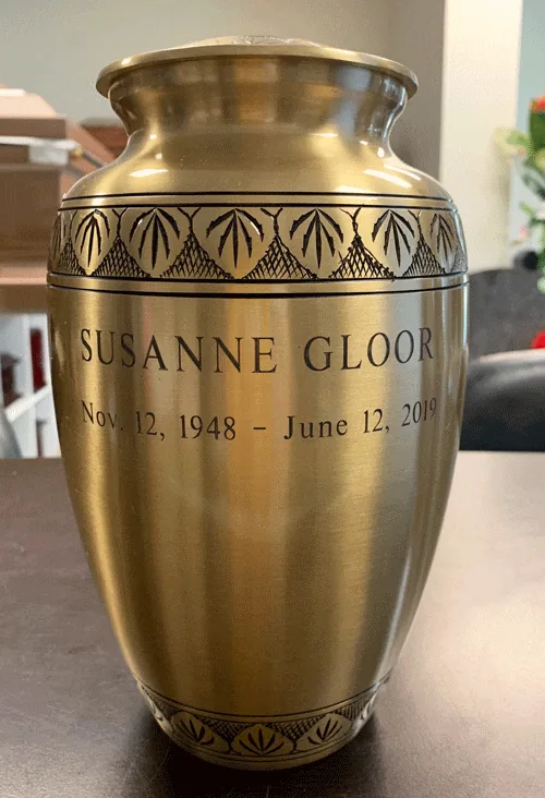 Sunlight Gleam Metal Urn MU105 Sunlight Gleam Metal Urn MU105, brushed gold tone urn with engraved leaf bands and a personalised name and dates