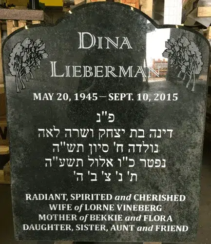 Tropical Green granite headstone with etched corner trees and Hebrew inscription